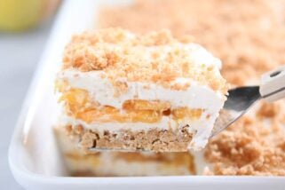 square of peaches and cream dessert on metal spatula