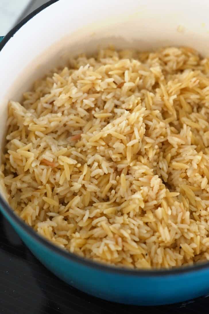 Fluffy, cooked rice pilaf in cast iron pot.