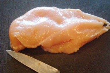 Chicken Breast raw chicken breast about to be cut