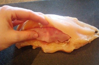Stuffing 1 raw chicken breast stuffed with ham and cheese