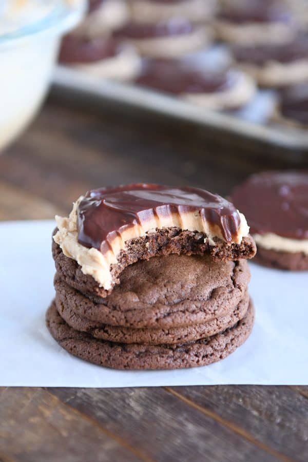 Stack of chocolate peanut butter buckeye cookies with bite taken out.