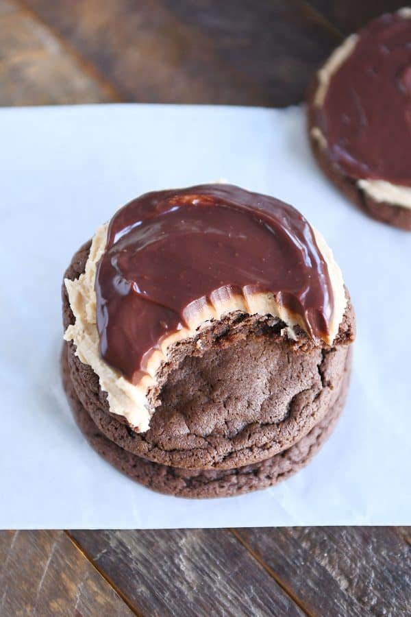 Stack of chocolate peanut butter buckeye cookies with bite taken out.