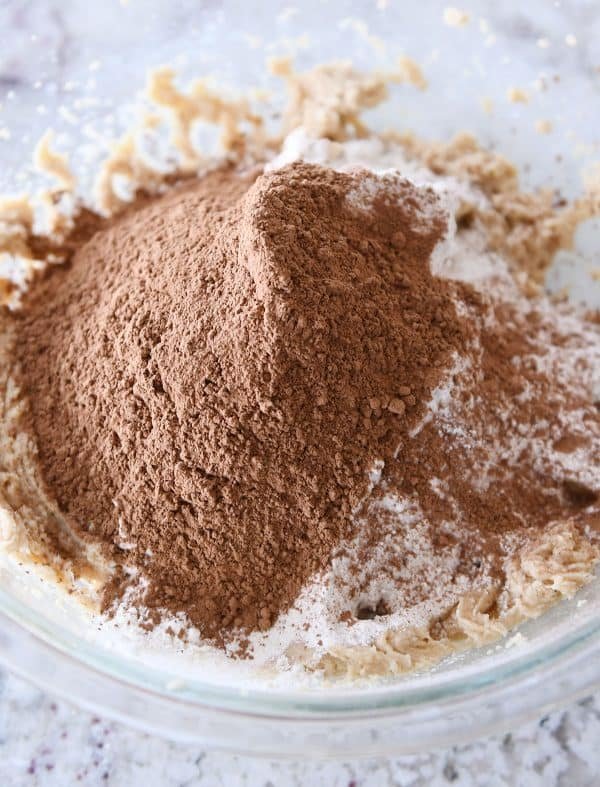 Dry ingredients in glass bowl for chocolate peanut butter buckeye cookies.