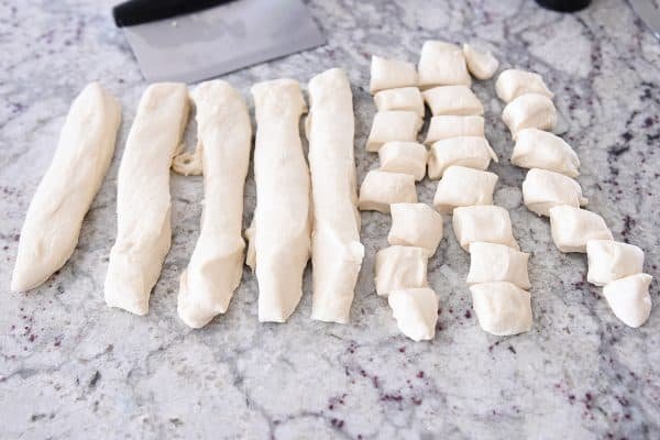 Cutting pull-apart bubble bread into strips.