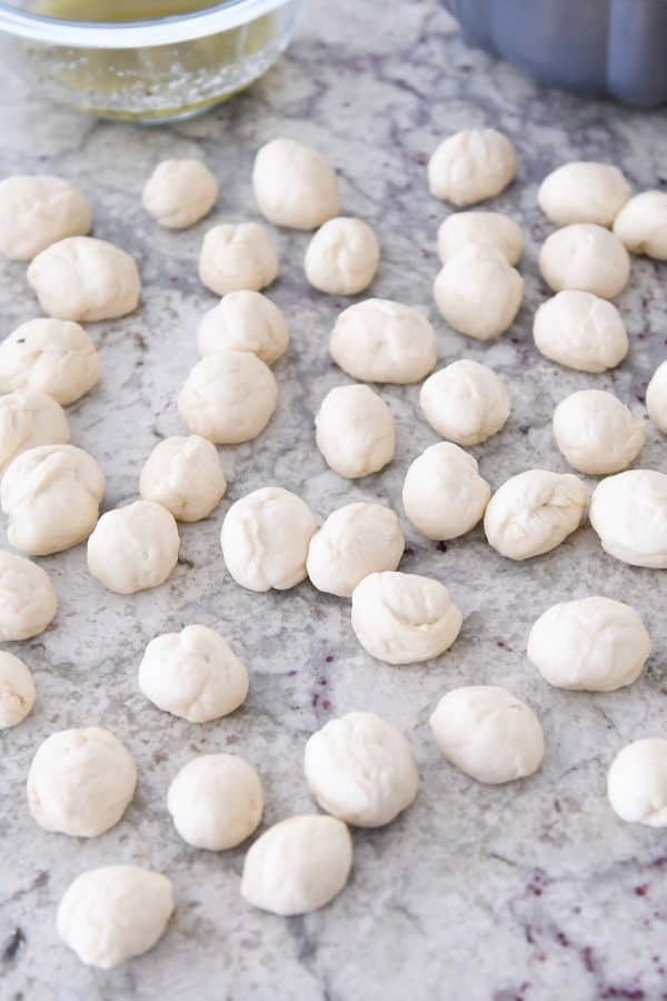 Rolling all the dough pieces for pull-apart bubble bread into balls.