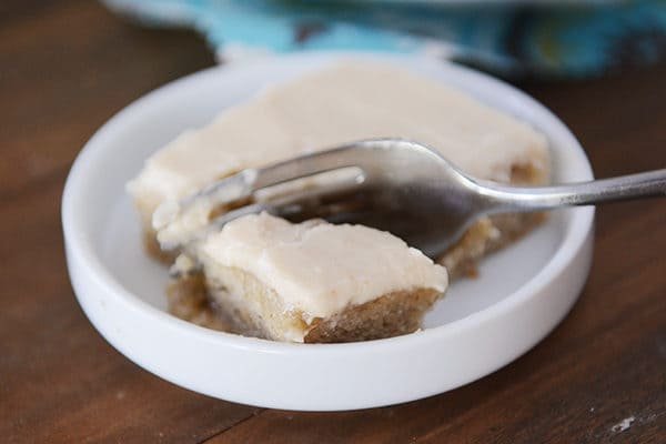 An iced banana bar with a fork taking a bite out.