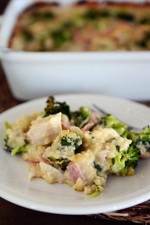 A big helping of cheesy chicken quinoa cordon bleu casserole on a white plate.