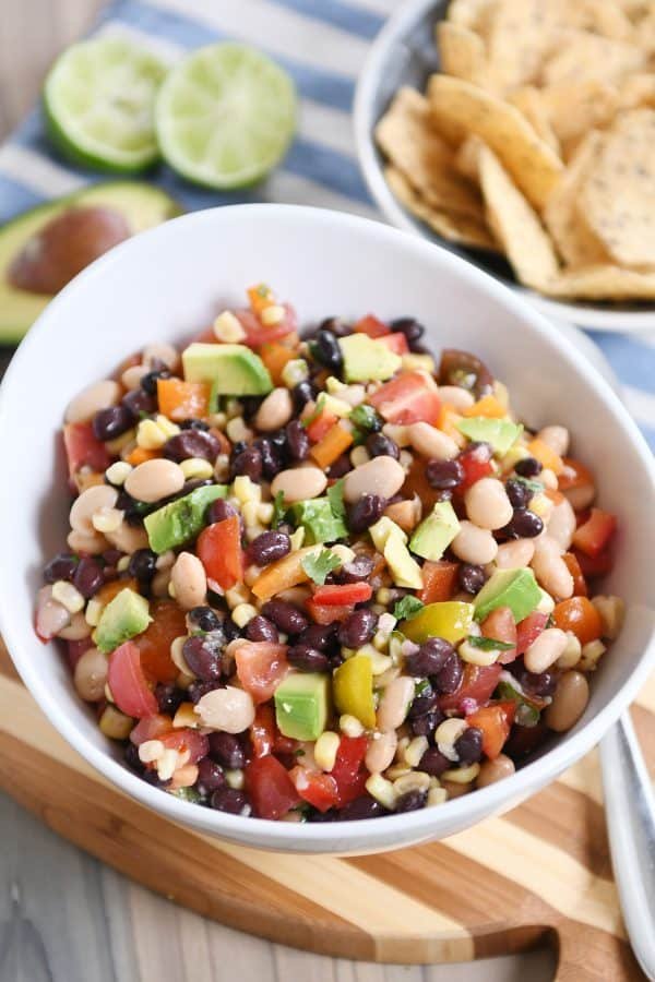 A bowl full of cowboy caviar dip in a white bowl.