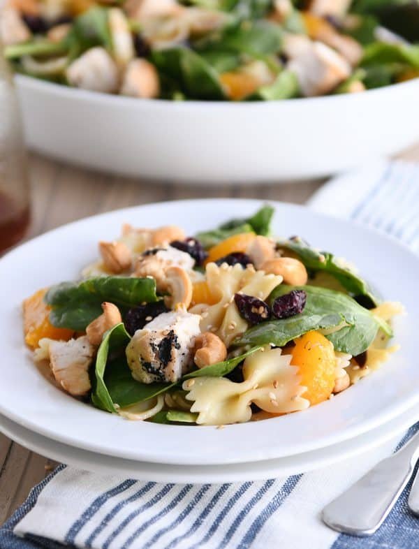 A serving of bowtie pasta salad dished up on white plate.