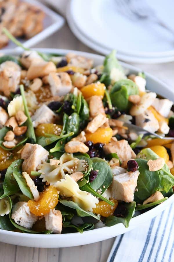 Bowtie pasta salad with teriyaki dressing in large white bowl.