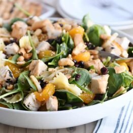 Bowtie pasta salad with teriyaki dressing in large white bowl.