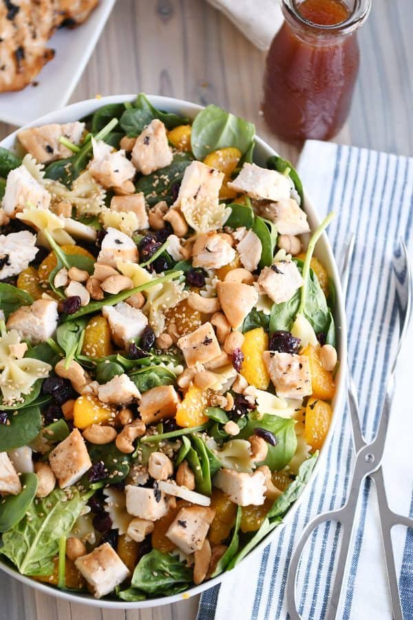 Top-down view of bowtie pasta salad with teriyaki dressing in large white bowl.